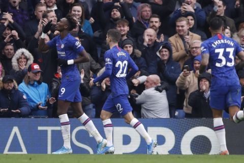 Chelsea's Tammy Abraham, left, celebrates with teammates after scoring his sides first goal during their English Premier League soccer match between Chelsea and Crystal Palace at Stamford Bridge stadium in London, Saturday, Nov. 9, 2019. (AP Photo/Alastair Grant)