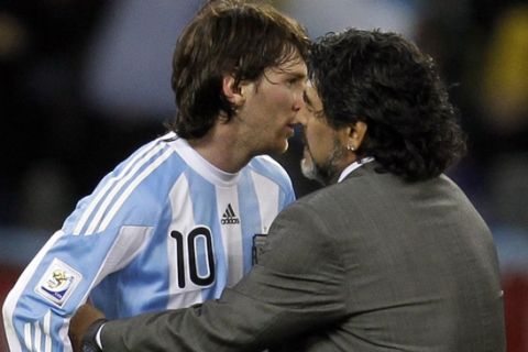 Argentina's Lionel Messi, left, is consoled by head coach Diego Maradona at the end of the World Cup quarterfinal soccer match between Argentina and Germany at the Green Point stadium in Cape Town, South Africa, Saturday, July 3, 2010. Germany won 4-0. (AP Photo/Matt Dunham)