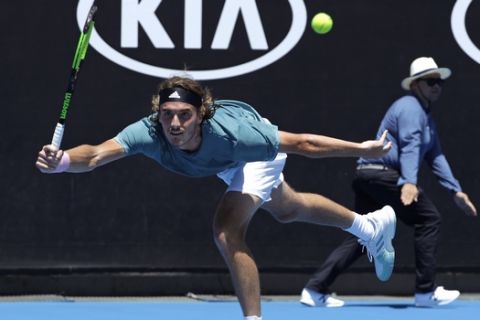 Greece's Stefanos Tsitsipas reaches for a forehand return to Italy's Matteo Berrettini during their first round match at the Australian Open tennis championships in Melbourne, Australia, Monday, Jan. 14, 2019. (AP Photo/Mark Schiefelbein)