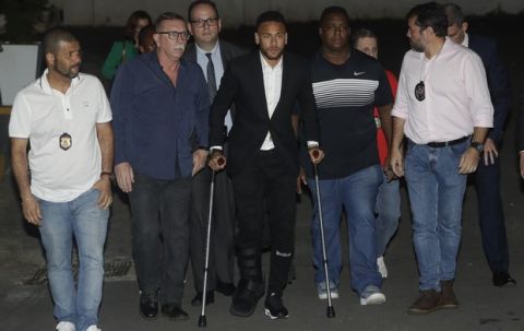 Using crutches because of an injured right ankle, Brazil's soccer player Neymar leaves a police station where he answered questions about rape allegations against him in Sao Paulo, Brazil, Thursday, June 13, 2019. Neymar denies any wrongdoing. (AP Photo/Andre Penner)
