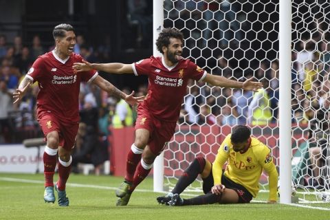 Liverpool's Mohamed Salah, center, celebrates scoring his side's third goal during the English Premier League soccer match at Vicarage Road, Watford, England, Saturday, August 12, 2017. (Daniel Hambury/PA via AP)