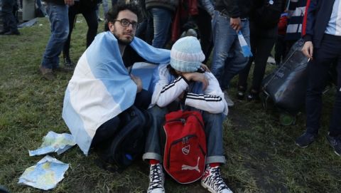 An Argentina fan comforts a friend at the end of a televised broadcast of the Croatia vs Argentina World Cup soccer match, in Buenos Aires, Argentina, Thursday, June 21, 2018. Argentina lost 3-0 to Croatia. (AP Photo Jorge Saenz)