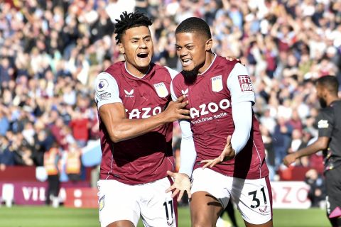 Aston Villa's Leon Bailey celebrates with Ollie Watkins, left, after scoring the opening goal during the English Premier League soccer match between Aston Villa and Brentford at Villa Park in Birmingham, England, Sunday, Oct. 23, 2022. (AP Photo/Rui Vieira)