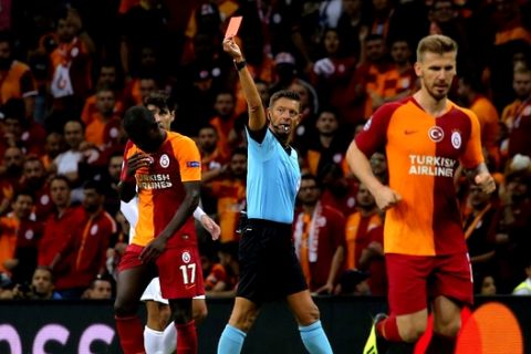 Galatasaray's midfielder Badou Ndiaye is sent off by referee Gianluca Rocchi, of Italy, after booked for 2nd time, during the Champions League Group D soccer match between Galatasaray and Lokomotiv Moscow in Istanbul, Tuesday, Sept. 18, 2018. (AP Photo)