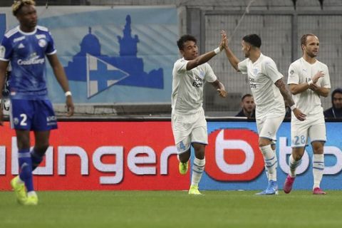 Marseille's Boubacar Kamara, center, celebrates with teammates after scoring his side's opening goal during the French League One soccer match between Marseille and Strasbourg at the Velodrome stadium in Marseille, southern France, Sunday, Oct. 20, 2019. (AP Photo/Daniel Cole)