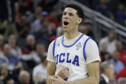 UCLA's Lonzo Ball reacts after scoring against Southern California during the first half of an NCAA college basketball game in the quarterfinals of the Pac-12 men's tournament Thursday, March 9, 2017, in Las Vegas. (AP Photo/John Locher)