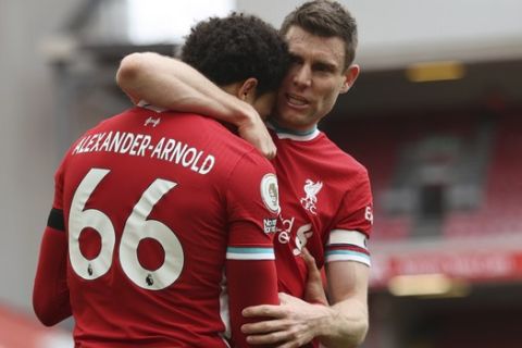 Liverpool's Trent Alexander-Arnold, left, celebrates with teammate Liverpool's James Milner after scoring his side's second goal during the English Premier League soccer match between Liverpool and Aston Villa at Anfield stadium in Liverpool, England, Saturday, April 10, 2021. (Clive Brunskill/Pool via AP)