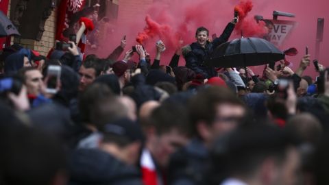 Liverpool supporters light red flares outside the stadium before the Champions League semifinal, first leg, soccer match between Liverpool and AS Roma at Anfield Stadium, Liverpool, England, Tuesday, April 24, 2018. (AP Photo/Dave Thompson)