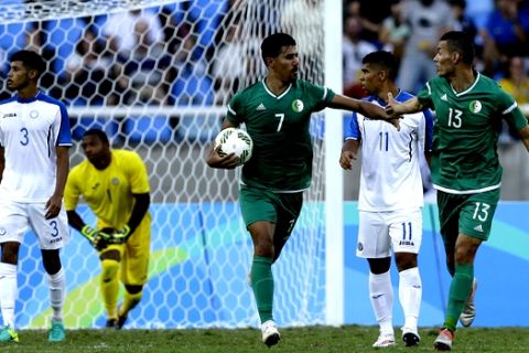 Algeria's Baghdad Bounedjah carries the ball after he scored against Honduras, as he celebrates with his teammate Oussama Darfalou during a group D match of the men's Olympic football tournament at the Rio Olympic Stadium in Rio De Janeiro, Brazil, Thursday, Aug. 4, 2016. (AP Photo/Leo Correa)