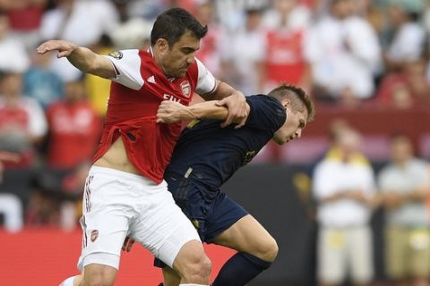 Arsenal defender Sokratis, left, battles for the ball against Real Madrid midfielder Toni Kroos (8) during the first half of an International Champions Cup soccer match, Tuesday, July 23, 2019, in Landover, Md. (AP Photo/Nick Wass)