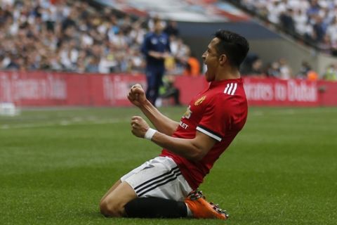 Manchester United's Alexis Sanchez celebrates after scoring his sides 1st goal during the English FA Cup semifinal soccer match between Manchester United and Tottenham Hotspur at Wembley stadium in London, Saturday, April 21, 2018. (AP Photo/Frank Augstein)