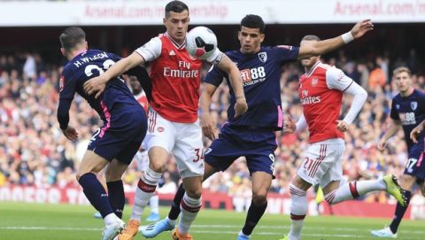 From left, Bournemouth's Harry Wilson, Arsenal's Granit Xhaka and Bournemouth's Dominic Solanke go for the ball during the English Premier League soccer match between Arsenal and Bournemouth at the Emirates stadium in London, Sunday, Oct. 6, 2019. (AP Photo/Leila Coker)