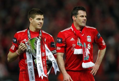 LONDON, ENGLAND - FEBRUARY 26:  Steven Gerrard and Jamie Carragher of Liverpool celebrate with the trophy after victory in the Carling Cup Final match between Liverpool and Cardiff City at Wembley Stadium on February 26, 2012 in London, England. Liverpool won 3-2 on penalties.  (Photo by Paul Gilham/Getty Images)