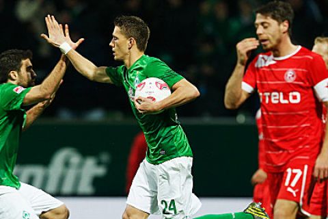 BREMEN, GERMANY - NOVEMBER 18: Nils Petersen (2nd L) of Bremen celebrates with his team mate Sokratis Papastathopoulos after scoring his team's first goal during the Bundesliga match between SV Werder Bremen and Fortuna Duesseldorf at Weser Stadium on November 18, 2012 in Bremen, Germany.  (Photo by Joern Pollex/Bongarts/Getty Images)