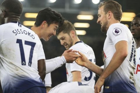 Tottenham's Harry Kane, right, celebrates after scoring with teammate Son Heung-min during the English Premier League soccer match between Everton and Tottenham at Goodison Park Stadium, in Liverpool, England, Sunday, Dec. 23, 2018. (AP Photo/Jon Super)