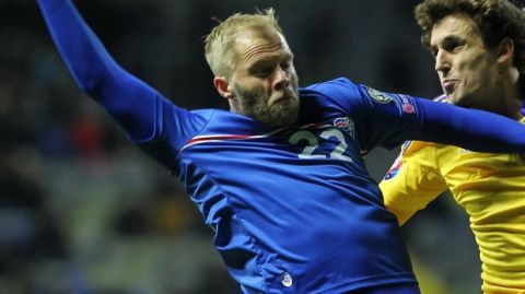 Iceland's Eidur Gudjohnsen, left, and Kazakhstan's  Yuri Logvinenko jump for a ball during the Euro 2016 qualifying soccer match between Kazakhstan and Iceland at Astana Arena stadium in Astana, the capital of Kazakhstan, Saturday, March 28, 2015. (AP Photo/Alexei Filippov)