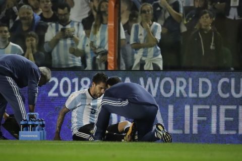 Argentina's Fernando Gago is attended by medics during a World Cup qualifying soccer match against Peru, at La Bombonera stadium in Buenos Aires, Argentina, Thursday, Oct. 5, 2017. (AP Photo/Victor R. Caivano)