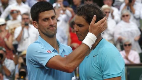 Spain's Rafael Nadal, right, is congratulated by Serbia's Novak Djokovic after winning the final of the French Open tennis tournament at the Roland Garros stadium, in Paris, France, Sunday, June 8, 2014. Nadal won in four sets 3-6, 7-5, 6-2, 6-4. (AP Photo/Michel Euler)