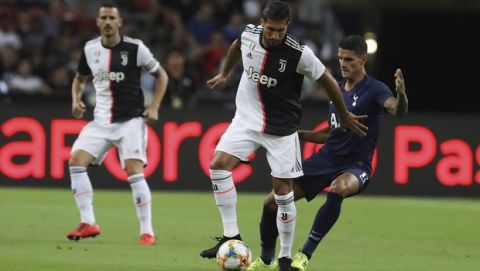 Juventus's Emre Can, center, in action during the International Champions Cup soccer match between Juventus and Tottenham Hotspur in Singapore, Sunday, July 21, 2019. (AP Photo/Danial Hakim)