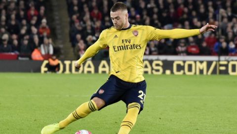 Arsenal's Calum Chambers kicks the ball during the English Premier League soccer match between Sheffield United and Arsenal at Bramall Lane in Sheffield, England, Monday, Oct. 21, 2019. (AP Photo/Rui Vieira)