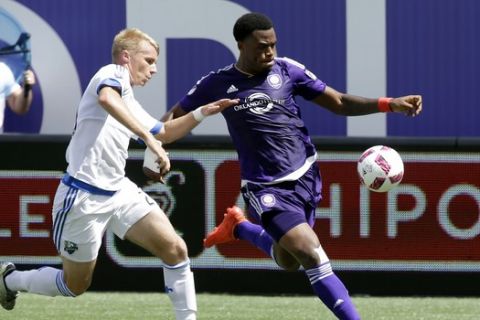 Montreal Impact's Kyle Fisher, left, tries to get the ball away from Orlando City's Cyle Larin during the first half of an MLS soccer game, Sunday, Oct. 2, 2016, in Orlando, Fla. (AP Photo/John Raoux)
