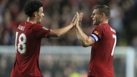 Liverpool's James Milner, right, celebrates scoring his sides goal with Liverpool's Curtis Jones during the League Cup soccer match between Milton Keynes Dons and Liverpool at the MK Dons Stadium, Milton Keynes England, in London, England, Wednesday, Sept. 25, 2019. (AP Photo/Leila Coker)