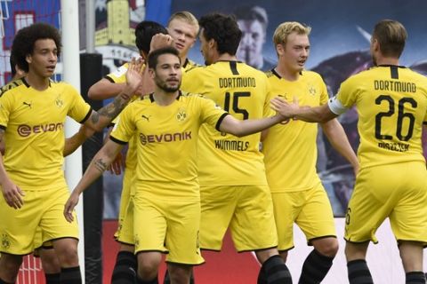 Dortmund's Erling Braut Haaland, center background, celebrates with his teammates after he scored his side's first goal during the German Bundesliga soccer match between RB Leipzig and Borussia Dortmund in Leipzig, Germany, Saturday, June 20, 2020. (AP Photo/Jens Meyer, Pool)
