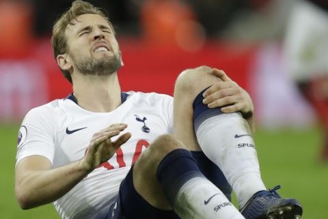 Tottenham's Harry Kane sits on the pitch with an injury after the English Premier League soccer match between Tottenham Hotspur and Manchester United at Wembley stadium in London, England, Sunday, Jan. 13, 2019. (AP Photo/Matt Dunham)