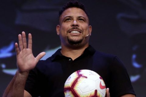Former Brazilian soccer star Ronaldo Luis Nazario waves to the crowd before a conference of the World Football summit in Madrid, Spain, Tuesday, Sept. 25, 2018. (AP Photo/Manu Fernandez)