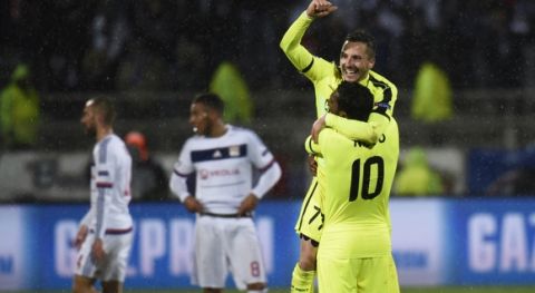 Gent's Serbian midfielder Danijel Milicevic (C) jubilates with Gent's Brazilian midfielder Renato Neto (R) at the end of the UEFA Champions League group H football match between Lyon and Gent on November 24, 2015 at the Gerland stadium in Lyon, southeastern France. AFP PHOTO / PHILIPPE DESMAZES / AFP / PHILIPPE DESMAZES        (Photo credit should read PHILIPPE DESMAZES/AFP/Getty Images)