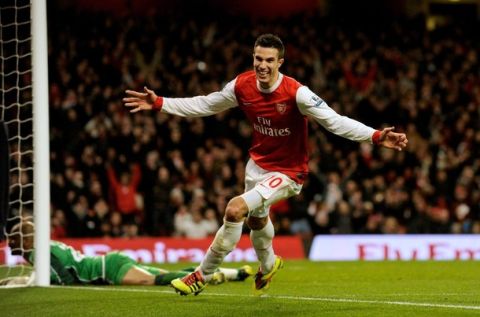 Arsenal's Robin van Persie celebrates after his third goal against Wigan Athletic during their English Premier League soccer match at the Emirates Stadium in London in this January 22, 2011 file photograph. Arsenal's striker van Persie, 28, was named the English Professional Footballers' Association (PFA) player of the year on April 22, 2012 after scoring 27 league goals to revive his club's season. The Dutch international tops the Premier League scoring charts and Arsenal's third spot with three matches to go after a poor start to the campaign is in large part down to his stunning contribution. REUTERS/Philip Brown/Files (BRITAIN - Tags: SPORT SOCCER) NO USE WITH UNAUTHORIZED AUDIO, VIDEO, DATA, FIXTURE LISTS, CLUB/LEAGUE LOGOS OR "LIVE" SERVICES. ONLINE IN-MATCH USE LIMITED TO 45 IMAGES, NO VIDEO EMULATION. NO USE IN BETTING, GAMES OR SINGLE CLUB/LEAGUE/PLAYER PUBLICATIONS. FOR EDITORIAL USE ONLY. NOT FOR SALE FOR MARKETING OR ADVERTISING CAMPAIGNS