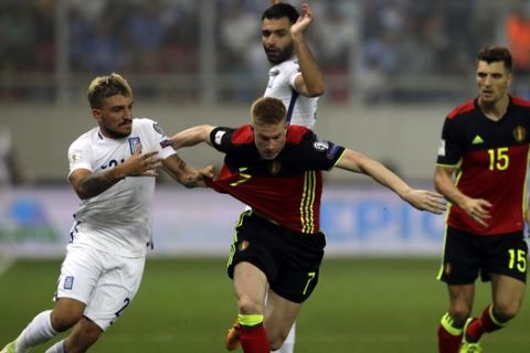 Belgium's Kevin De Bruyne, center, vies for the ball with Greece's Kostas Stafylidis, left, during the World Cup Group H qualifying soccer match between Greece and Belgium at Georgios Karaiskakis Stadium in Piraeus port, near Athens, Sunday, Sept. 3, 2017. (AP Photo/Thanassis Stavrakis)