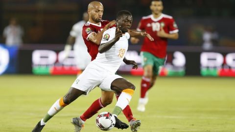 In this Friday, June 28, 2019 photo, Ivory Coast's Nicolas Pepe, front, in action in front of Morocco's Karim El Ahmadi Aroussi during the African Cup of Nations group D soccer match between Morocco and Ivory Coast in Al Salam Stadium in Cairo, Egypt. (AP Photo/Ariel Schalit)
