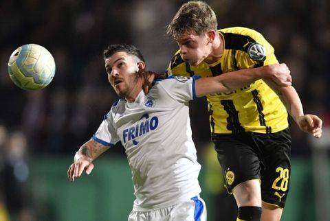 Lotte's Bernd Rosinger, left, and Dortmund's Matthias Ginter challenge for the ball during the German Soccer Cup quarterfinal match between SF Lotte and Borussia Dortmund in Osnabrueck, Germany, Tuesday, March 14, 2017. (AP Photo/Martin Meissner)