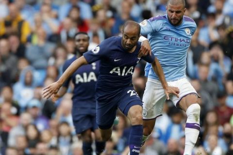 Tottenham's Lucas Moura, left, duels for the ball with Manchester City's Kyle Walker during the English Premier League soccer match between Manchester City and Tottenham Hotspur at Etihad stadium in Manchester, England, Saturday, Aug. 17, 2019. (AP Photo/Rui Vieira)