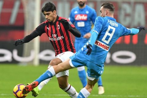 Milan's Lucas Paquet' left, and Napoli's Fabian Ruiz in action during their Italian Serie A soccer match between AC Milan and Napoli, at the San Siro stadium in Milan, Italy, Saturday, Jan. 26, 2019. (AP Photo/Antonio Calanni)