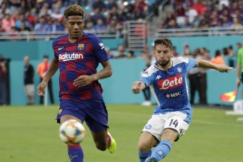 Napoli's Dries Mertens (14) passes the ball as Barcelona's Jean-Clair Todibo defends during the first half of a soccer match Wednesday, Aug. 7, 2019, in Miami Gardens, Fla. Barcelona won 2-1. (AP Photo/Lynne Sladky)