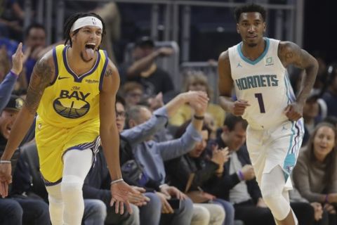 Golden State Warriors guard Damion Lee, left, reacts after scoring next to Charlotte Hornets guard Malik Monk during the first half of an NBA basketball game in San Francisco, Saturday, Nov. 2, 2019. (AP Photo/Jeff Chiu)