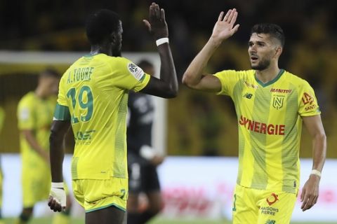 Abdoulaye Toure of Nantes, right, shakes hand with Medhi Abeid at the end of the French League One soccer match between Nantes and Montpellier at the La Beaujoire Stadium in Nantes, western France, Saturday, Aug. 31, 2019. Nantes won 1-0. (AP Photo/David Vincent)