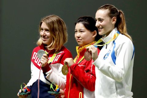 Gold medal winner, Zhang Mengxue of China, center, poses for a picture with silver medal winner, Vitalina Batsarashkina of Russia, left, and bronze medalist Anna Korakaki of Greece, during the victory ceremony for the women's 10-meter air pistol event at the 2016 Summer Olympics in Rio de Janeiro, Brazil, Sunday, Aug. 7, 2016. (AP Photo/Hassan Ammar)