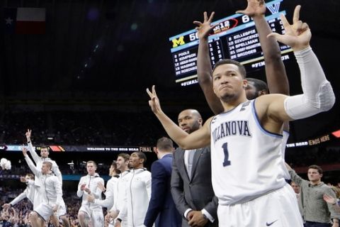 Villanova's Jalen Brunson (1) and players on Villanova bench react to a 3-point basket during the second half in the championship game of the Final Four NCAA college basketball tournament against Michigan, Monday, April 2, 2018, in San Antonio. (AP Photo/David J. Phillip)