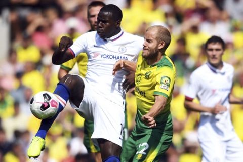 Chelsea's Kurt Zouma, left, and Norwich City's Teemu Pukki battle for the ball during the English Premier League soccer match between Norwich City and Chelsea at the Carrow Road Stadium, Norwich, England. Saturday, Aug, 24 2019. (Joe Giddens/PA via AP)