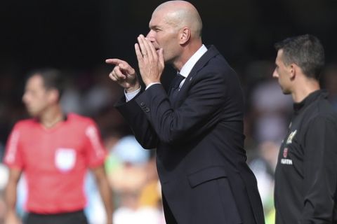 Real Madrid's head coach Zinedine Zidane gives orders from the touchline during La Liga soccer match between Celta and Real Madrid at the Balaídos Stadium in Vigo, Spain, Saturday, Aug. 17, 2019. (AP Photo/Luis Vieira)