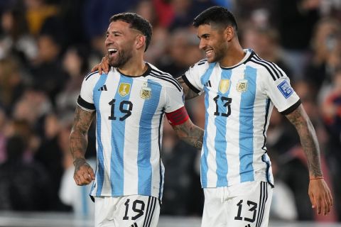 Argentina's Nicolas Otamendi, left, celebrates with teammate Cristian Romero after scoring the opening goal during a qualifying soccer match for the FIFA World Cup 2026 between Argentina and Paraguay at Monumental stadium in Buenos Aires, Argentina, Thursday, Oct. 12, 2023. (AP Photo/Natacha Pisarenko)