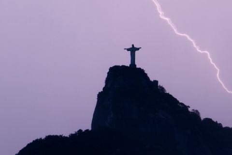 A lightning strikes near the statue of Christ the Redeemer in Rio de Janeiro, Tuesday, Jan. 19, 2010. (AP Photo/Felipe Dana)