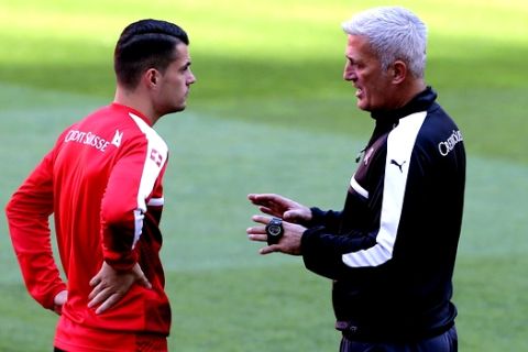 Switzerland coach Vladimir Petkovic, right, talks with Switzerland's Granit Xhaka during a training session at the Luz stadium in Lisbon, Monday, Oct. 9, 2017. Switzerland will face Portugal in a World Cup Group B qualifying soccer match in Lisbon Tuesday. (AP Photo/Armando Franca)