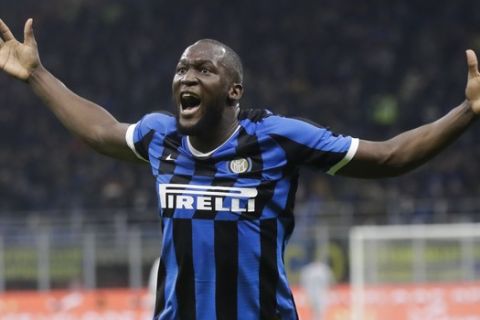 Inter Milan's Romelu Lukaku celebrates after his teammate Roberto Gagliardini scored his side's second goal during a Serie A soccer match between Inter Milan and Genoa, at the San Siro stadium in Milan, Italy, Saturday, Dec. 21, 2019. (AP Photo/Luca Bruno)