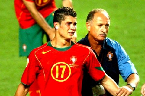 Portugal coach Luiz Felipe Scolari, right, leads a tearful Cristiano Ronaldo to collect his runners-up medal after Greece beat Portugal 1-0 in the Euro 2004 soccer championship final match at the Luz stadium in Lisbon, Portugal, Sunday, July 4, 2004. (AP Photo/Luca Bruno) **  FOR EDITORIAL USE ONLY NO WIRELESS COMMERCIAL OR PROMOTIONAL LICENSING PERMITTED  **