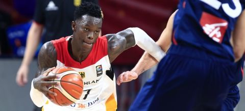 Germany's Dennis Schroder, left, drives to the basket against France's Louis Labeyrie during their Eurobasket European Basketball Championship round of 16 match in Istanbul, Saturday, Sept. 9. 2017. (AP Photo/Lefteris Pitarakis)