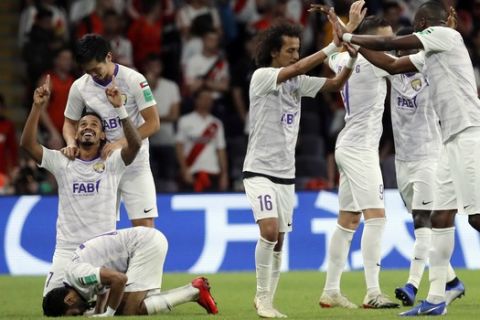 Emirates's Al Ain Caio, left, celebrates with teammates after scoring his side's second goal during the Club World Cup semifinal soccer match between Al Ain Club and River Plate at the Hazza Bin Zayed stadium in Al Ain, United Arab Emirates, Tuesday, Dec. 18, 2018. (AP Photo/Hassan Ammar)